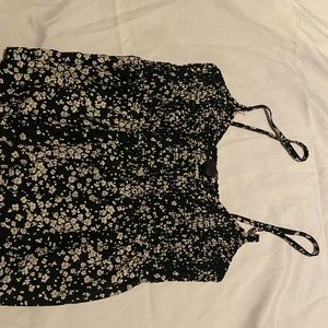 Black shirts with small tan/white flower design. Tank top with flowy bottom